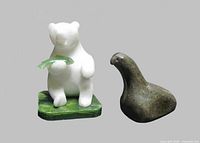 White stone polar bear holding jade green fish and dark soapstone Inuit loon shown front view
