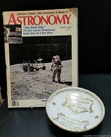 Photo showing the commemorative Aynsley china dish with gold print and the accompanying Apollo 11 20th Anniversary Astronomy magazine.