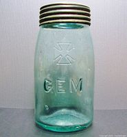 Front view of the large aqua glass GEM canning jar with visible embossing.