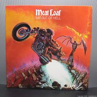 Front cover of the Meat Loaf Bat Out of Hell 1977 vinyl LP showing detailed, colorful artwork of a motorcyclist and bat flying against an orange sky.