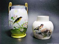 Front view of Nippon vase with yellow and black bird and pink flowers, and Noritake candle holder showing bird and berry pattern with printed text