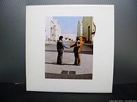Front cover of Pink Floyd Wish You Were Here LP showing two men shaking hands with one on fire, white background with minor aging