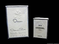 Front view of the sealed Oscar de la Renta Eau de Toilette 30 ml box next to the sealed Chanel No. 5 Parfum 7 ml box.