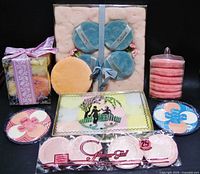 Full view of all powder puffs including boxed sets, loose round puffs, and flower-shaped compact puffs in assorted colors.
