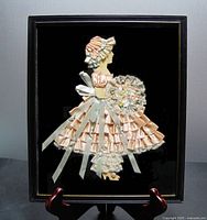 Front view of the framed ribbon art paper doll showing the overall piece, doll details, and frame structure.
