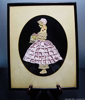 Full view of framed ribbon art paper doll with oval mat and wood frame