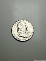 Obverse side showing Benjamin Franklin portrait with date 1963 and inscriptions.