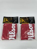 Front view of two red Wilson junior tote bags in original packaging with header cards.