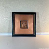 Framed metal engraved horse head artwork on a neutral background, showing entire item and framing