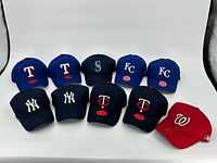 All 10 caps arranged in two rows, showing front logos and colors