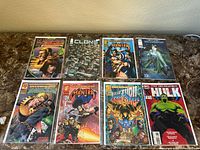 Front view of 8 comic books laid out on table in two rows, showing cover art for Ultraverse Hardcase, Mantra, Clone, The Incredible Hulk, and others.