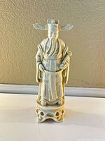 Front view of the resin Asian emperor statue showing detailed facial features, headdress, and robe designs.