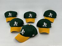 Six Oakland A's baseball hats arranged visually showing front logo and color scheme.