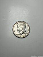 Obverse side of 1967 Kennedy Half Dollar Coin showing profile of John F. Kennedy with date 1967.