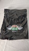 Black packaged women's shorts with Central Perk Friends logo embroidered on the front