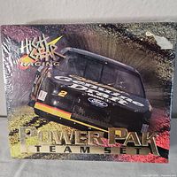 Sealed box front showing High Gear Racing Power Pak Team Set with a NASCAR stock car image.