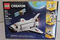 Front of the LEGO Creator 3-in-1 Space Shuttle set box showing the assembled space shuttle model and set details such as piece count and age recommendation.