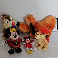 Full view of five Disney plush toys: Chip, Pluto, Simba, Minnie Mouse, and Mickey Mouse.
