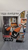 Photo of Mighty Muggs Star Wars Biggs Darklighter figure box showing character face and helmet design, brand logos, and exclusive Target edition sticker.