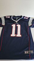 Front view of the navy blue youth jersey showing number 11 and Patriots logo