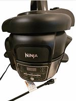 Front view of Ninja Foodi electric pressure cooker showing control panel, lid, and power cord.