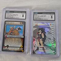 Two Dragonball Z graded cards encased in CGC holders. Left card is Orange Uppercut, graded 8. Right card is Raditz, graded 7.5.