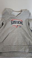 Front view of gray hoodie with 'New England Patriots Super Bowl Champions' and Super Bowl LIII logos