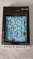 Front of the retail packaging showing light blue wallet with multiple Mr. Meeseeks faces from Rick and Morty.
