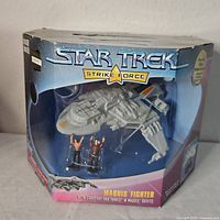 Boxed Star Trek Strike Force Maquis Fighter toy set showing spacecraft and two mini figures in packaging.