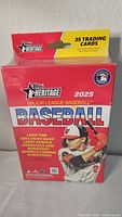 Front view of the sealed Topps 2025 Heritage Major League Baseball Blaster Box showing branding, player image, and details of exclusive cards.
