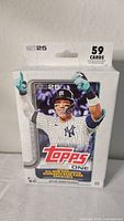 Front view of a new, sealed Topps 2025 Series 1 Baseball Hanger Box with 59 cards, featuring a Yankees player in uniform on the packaging.
