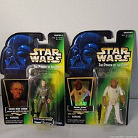 Front view of two Star Wars action figures, Grand Moff Tarkin and Admiral Ackbar, in sealed original Kenner Power of the Force Collection 2 packaging