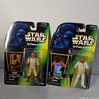 Photo showing two new vintage Star Wars action figures in original packaging: Bossk and Admiral Ackbar from The Power of the Force series.