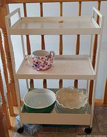 Front view of 3-tier cart with teapot and two bowls displayed on shelves