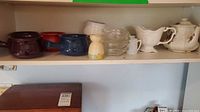 Shelf view of mixed kitchenware pieces