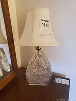 Lamp showing glass base with swirl texture and shade