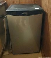 Front angled view of closed Danby compact refrigerator showing stainless door and black top