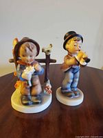 Both figurines front view showing overall design and scale