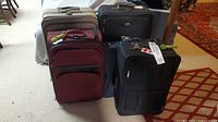 Front view of five upright suitcases grouped together