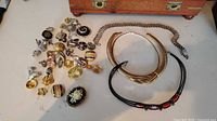 Overview of lot showing necklaces, bracelet and cluster of small jewelry items