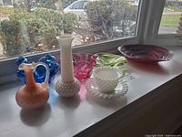 All seven glass pieces displayed on windowsill