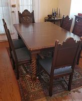Dining table with leaves removed, four chairs visible