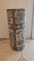 Front view of cylindrical porcelain umbrella stand with famille rose decoration