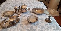 Full lot on table displaying all eight silver-plated pieces