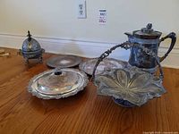 Group view of all six silverplated pieces on floor