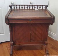 Front view showing spindle gallery, drop front closed