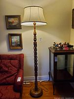 Full view of floor lamp beside furniture showing shade and base