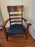 Front view showing slat back, arms, seat