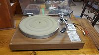 Front view of Yamaha YP-450 turntable showing platter, tonearm, dust cover, and control sliders