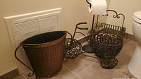 All four items grouped: hammered bucket planter, tricycle basket holder, toilet paper stand, magazine rack
